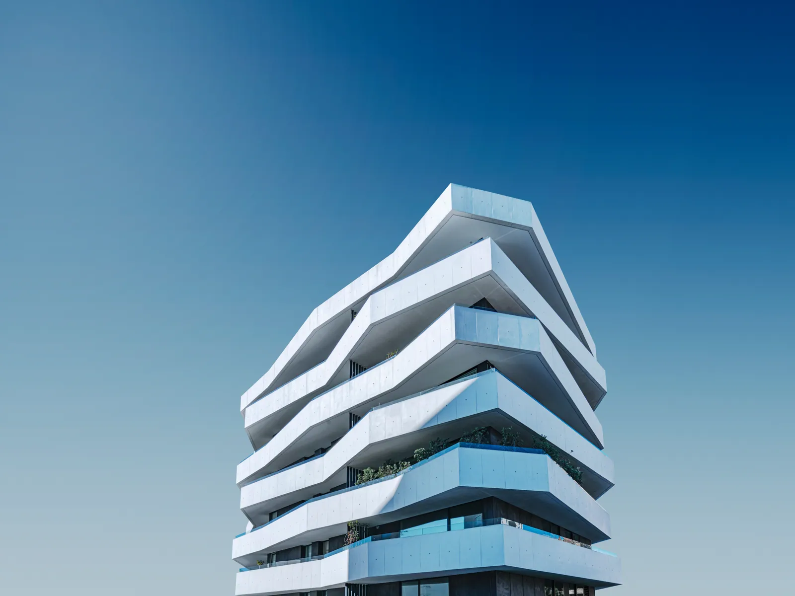 Sculptural terraces reaching into blue sky