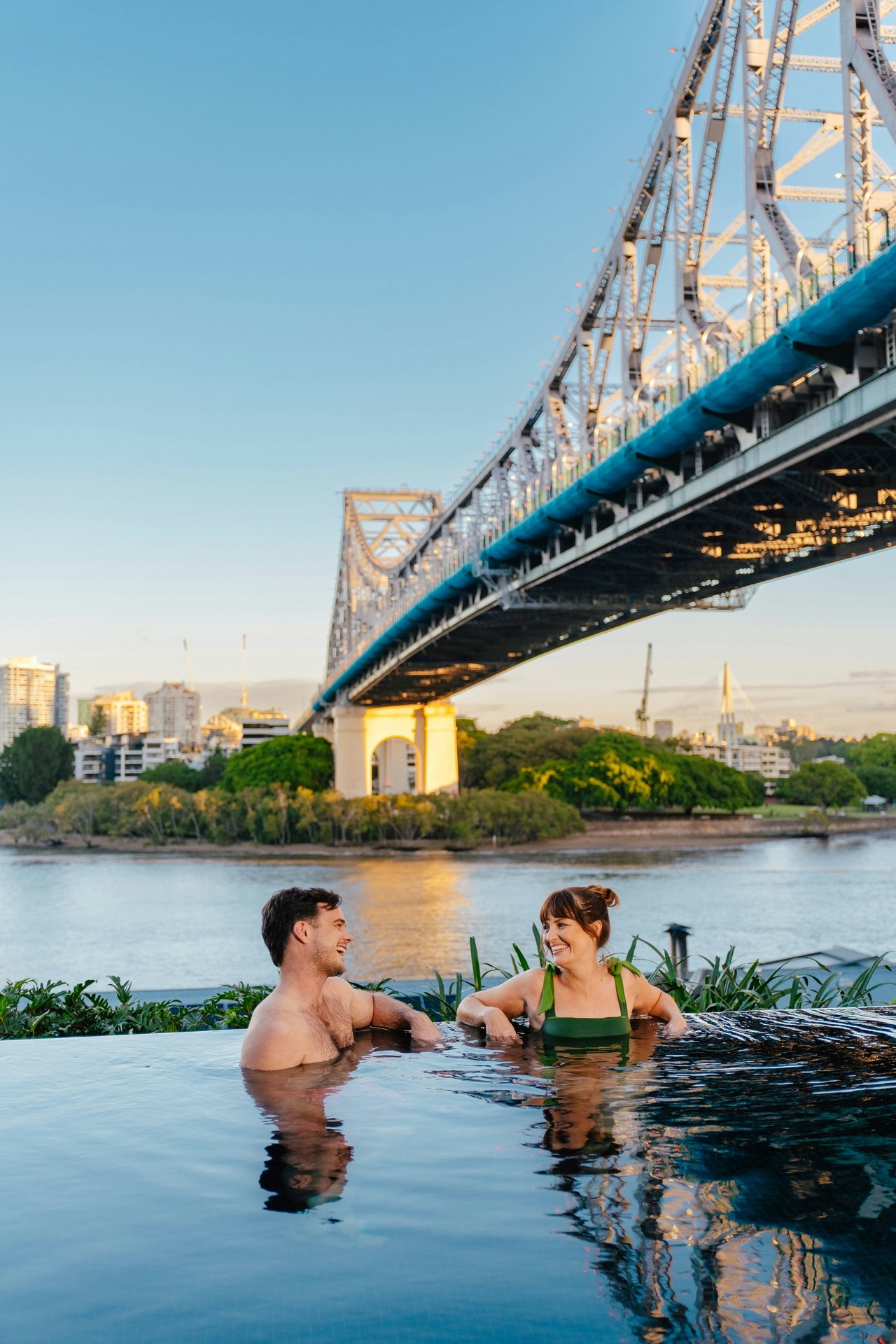 The Brisbane river beneath a steel bridge