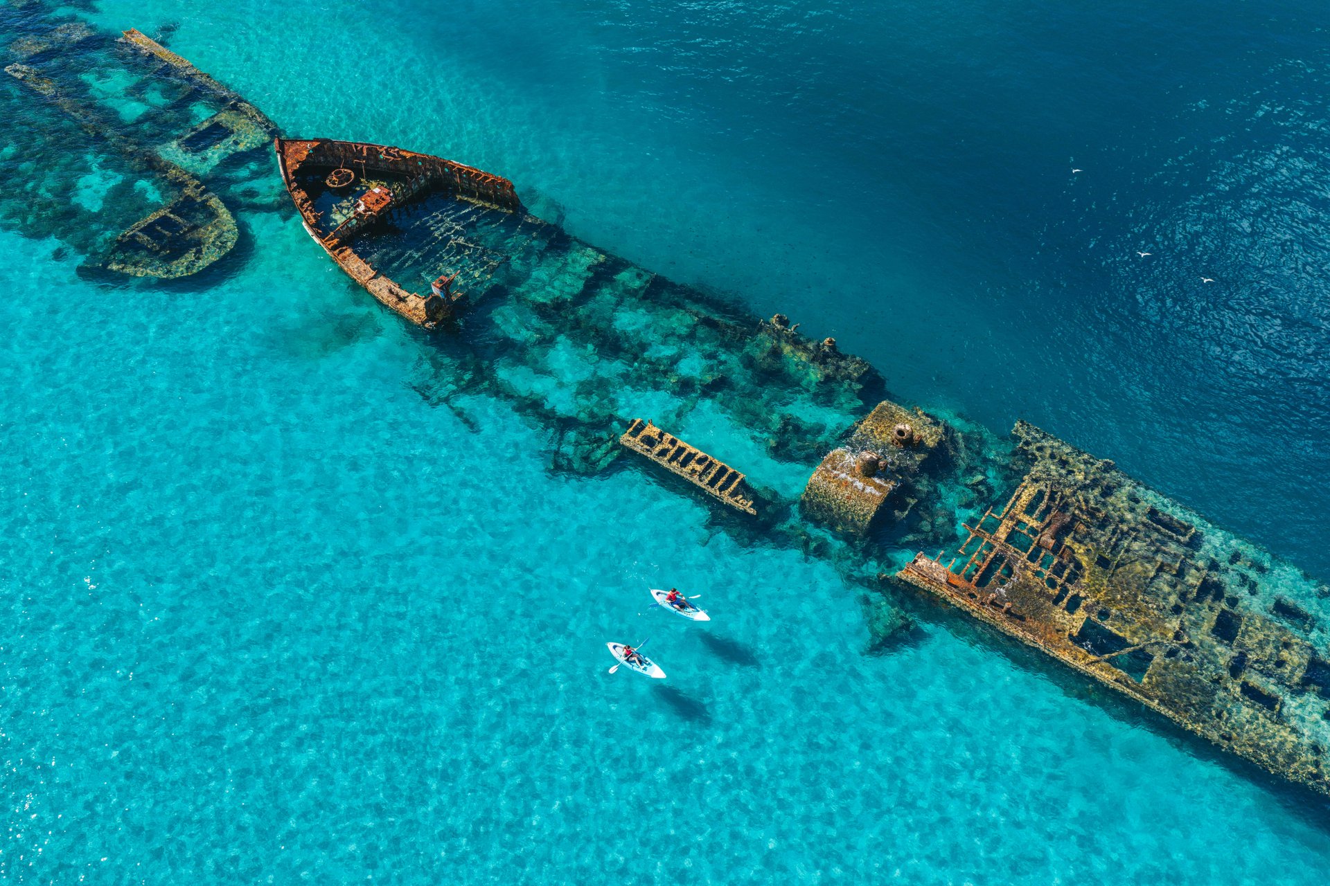 Wrecks lying in clear turquoise water off the Queensland coast