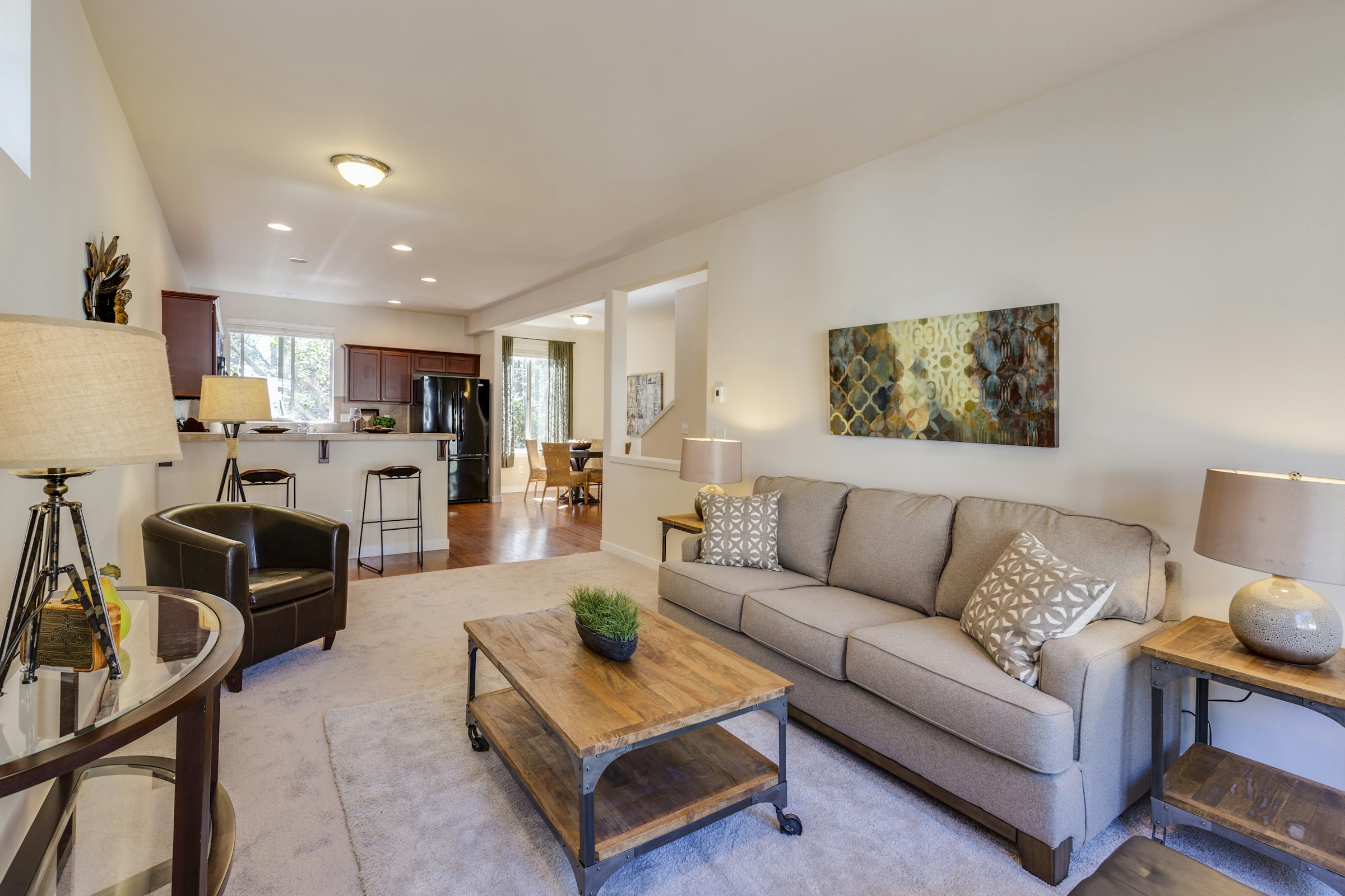 Open living room with a cream sofa, dining area and garden windows